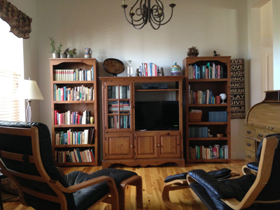 Den with bookcase full of books and TV.